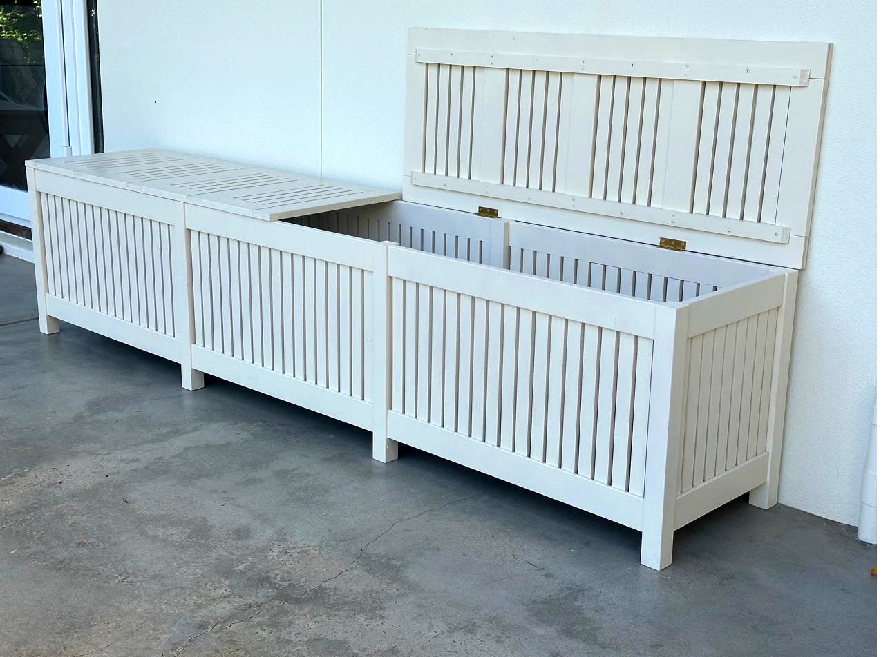 White painted outdoor storage bench with lid open showing interior